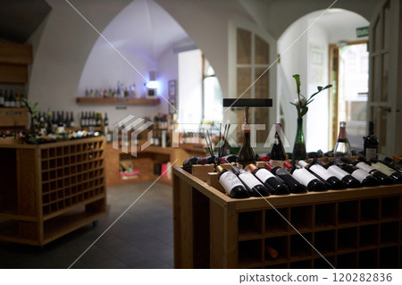 Ample dimly lit room with wooden wine cabin and rack prepared for upcoming degustation 120282836