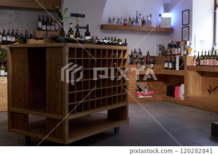 Ample modern wine cellar with wooden storages for wine bottles made in minimalist style Ample modern wine cellar with wooden storages for wine bottles made in minimalist style 120282841