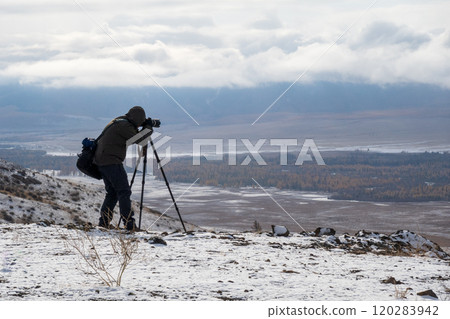 Photographer capturing winter landscape in Altai Mountains 120283942