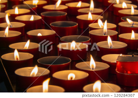 Rows of softly glowing tea light candles creating warm ambiance Rows of softly glowing tea light candles creating warm ambiance 120284307