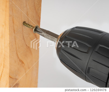 Screwing a screw into wood: strength and reliability in every movement. Screwing a screw into wood: strength and reliability in every movement. 120284478