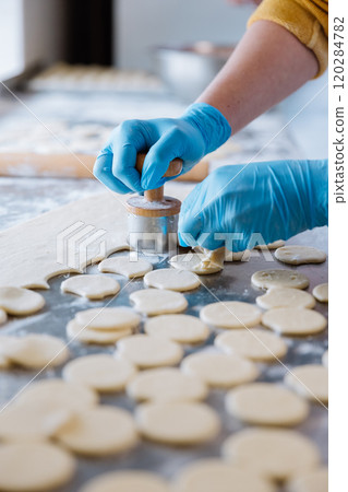 Preparing dough circles for traditional dumplings, showcasing handmade culinary craftsmanship 120284782