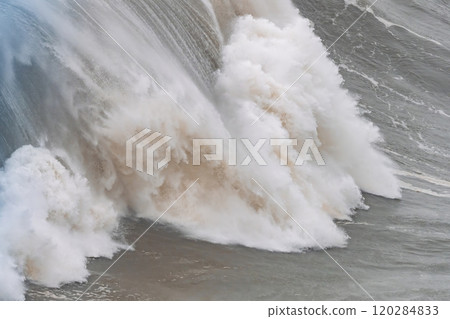 Huge wave crashing with dramatic foam and spray at Nazare in Portugal 120284833