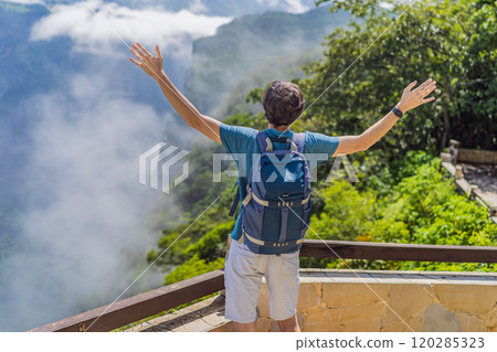 Male tourist exploring Sumidero Canyon National Park, Mexico. Adventure, natural exploration, and travel experience concept Male tourist exploring Sumidero Canyon National Park, Mexico. Adventure, natural exploration, and travel experience concept 120285323