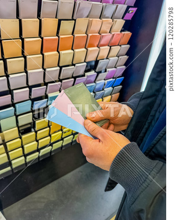 Customer Selecting Paint Swatches in Colourful Hardware Store Display. High quality photo 120285798