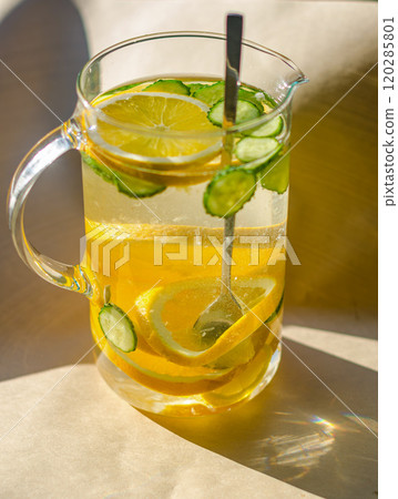 A carafe with water, a cucumber and a oranges stands on wooden background. High quality photo A carafe with water, a cucumber and a oranges stands on wooden background. High quality photo 120285801