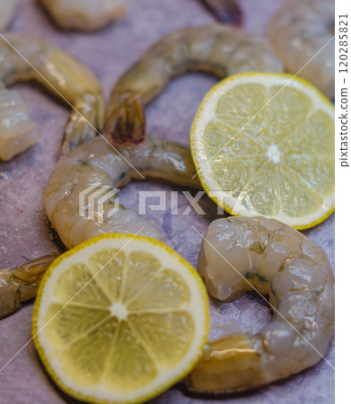 raw shrimps, prawns and slices of lemon on grey background . High quality photo 120285821