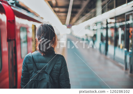Train and woman's back view Train and woman's back view 120286102