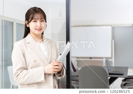 A young female staff member giving a tour of the company A young female staff member giving a tour of the company 120286525