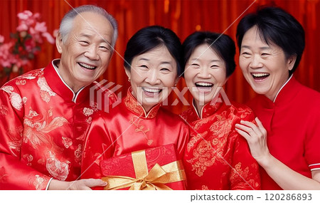 Four happy active Asian pensioners in traditional Chinese outfits celebrate the Eastern New Year 120286893