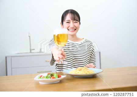 Young woman drinking beer 120287751