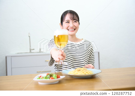 Young woman drinking beer 120287752