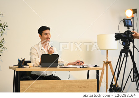 Confident successful businessman giving an interview for online media 120288164