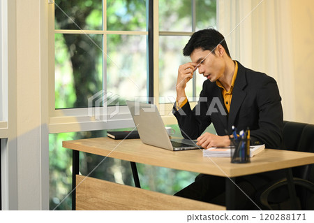 Frustrated businessman experiencing mental fatigue during office work 120288171