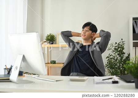Relaxed businessman enjoying a short break in his workspace 120288280