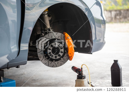 Checking car brake system for repair at car garage 120288911