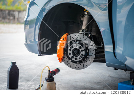Checking car brake system for repair at car garage 120288912