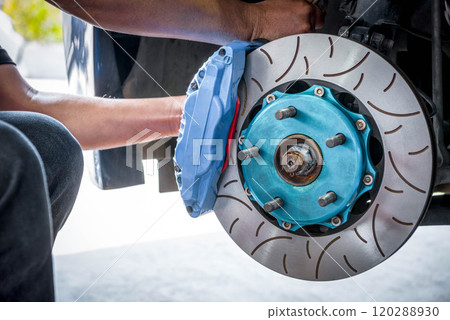 Checking car brake system for repair at car garage 120288930