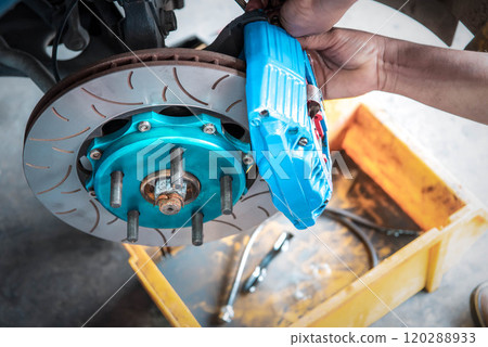 Checking car brake system for repair at car garage Checking car brake system for repair at car garage 120288933