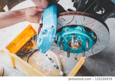 Checking car brake system for repair at car garage Checking car brake system for repair at car garage 120288934