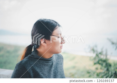 Woman (LGBTQ) posing at sea viewpoint with happy 120289137