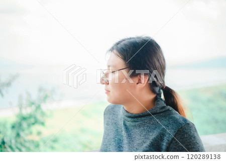 Woman (LGBTQ) posing at sea viewpoint with happy 120289138