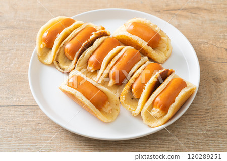 flat pancake roll with sausage 120289251