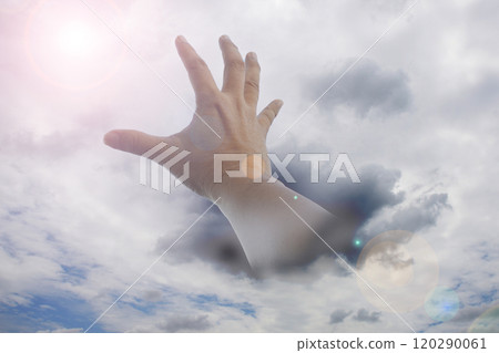 Hand reaching out from the turbulent clouds to grasp the chance of life. 120290061