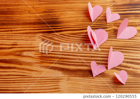 Composition of pink hearts on a wooden background 120290555