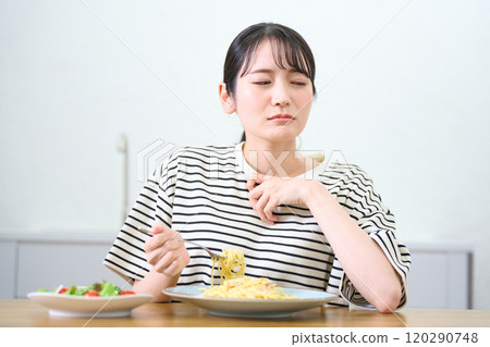 年輕女子吃麵食，食慾不振，擔憂 120290748