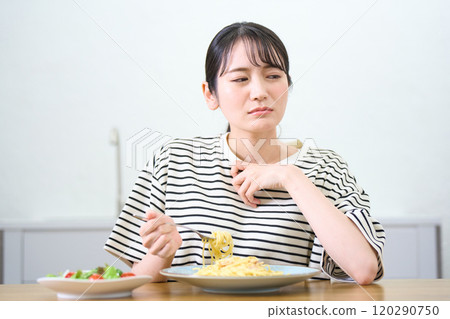 年輕女子吃麵食，食慾不振，擔憂 120290750