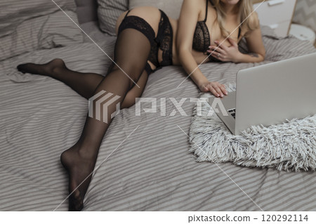 A beautiful, young girl shoots a webcam, works as a model. The concept of online flirting, sex on the Internet 120292114