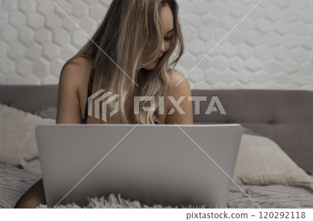 A beautiful, young girl shoots a webcam, works as a model. The concept of online flirting, sex on the Internet 120292118