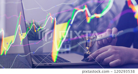 Digital Triumph in Real Estate Investment: A Trophy Representing Success, Model House, and a Laptop 120293538