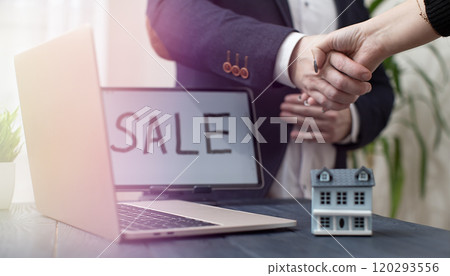 Handshake Agreement in Real Estate Sale with Laptop and Model House on Desk Handshake Agreement in Real Estate Sale with Laptop and Model House on Desk 120293556