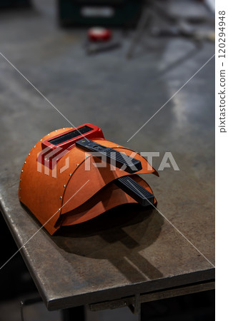 Welding mask on a work bench in a factory Welding mask on a work bench in a factory 120294948