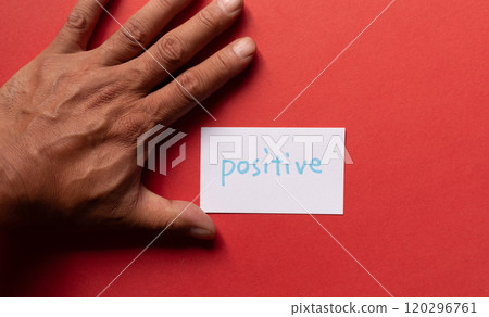 A person holding a card that says "positive" A person holding a card that says "positive" 120296761