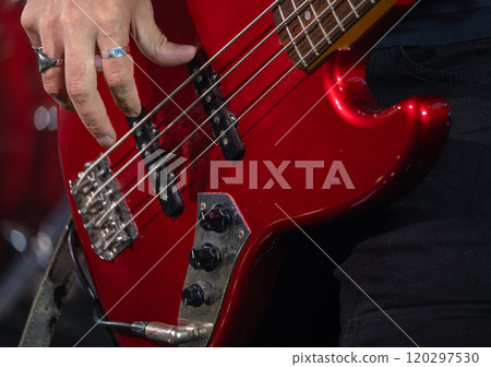 Musician playing electric bass guitar during live performance Musician playing electric bass guitar during live performance 120297530