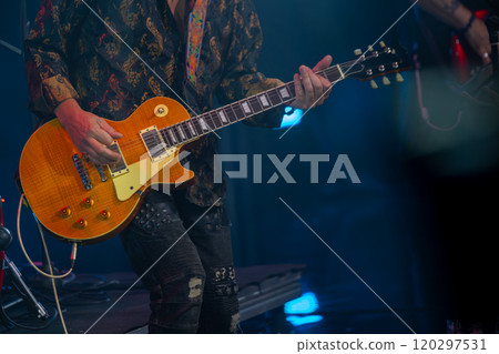 Close-up of musician playing electric guitar on stage 120297531