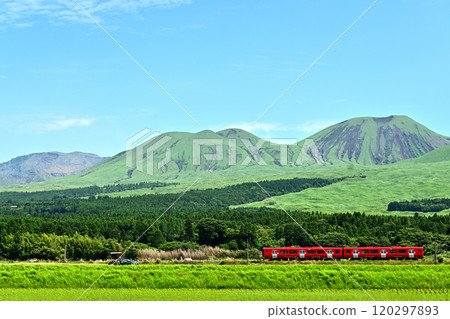 A red train running through the foothills of Mount Aso A red train running through the foothills of Mount Aso 120297893