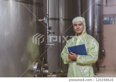 Winemaker working in modern large winery factory liquor drink industry quality. Staff inspecting wine in modern wine factory. Winery manufacturing quality control. Alcohol and wine winemaking process Winemaker working in modern large winery factory liquor drink industry quality. Staff inspecting wine in modern wine factory. Winery manufacturing quality control. Alcohol and wine winemaking process 120298628