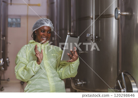 Winemaker working in modern large winery factory liquor drink industry quality. Staff inspecting wine in modern wine factory. Winery manufacturing quality control. Alcohol and wine winemaking process 120298646