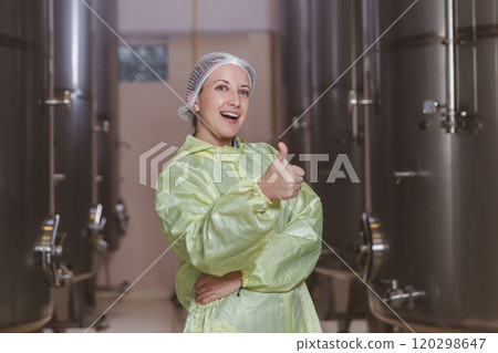 Winemaker working in modern large winery factory liquor drink industry quality. Staff inspecting wine in modern wine factory. Winery manufacturing quality control. Alcohol and wine winemaking process 120298647