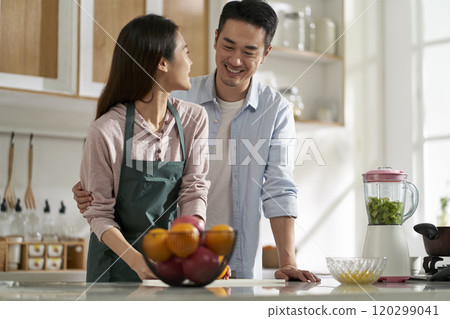 young asian couple talking chatting in kitchen young asian couple talking chatting in kitchen 120299041