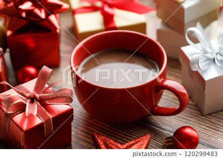 Cup of hot cocoa among vivid gift boxes 120299483