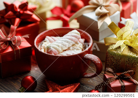 Cup of hot cocoa among vivid gift boxes 120299501