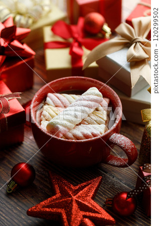 Cup of hot cocoa among vivid gift boxes 120299502