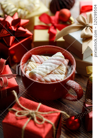 Cup of hot cocoa among vivid gift boxes 120299504