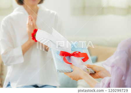 Parents and children giving Mother's Day presents 120299729