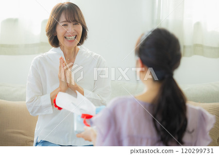 Parents and children giving Mother's Day presents Parents and children giving Mother's Day presents 120299731